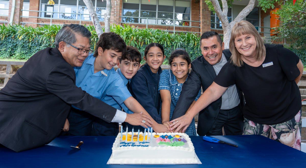 Most Rev Vincent Long OFM Conv, Bishop of the Diocese of Parramatta, alongside parish priest, Father Fernando and Bianca Cooke