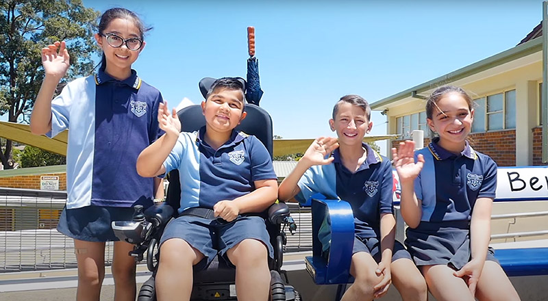 St Bernadette's Catholic Primary Castle Hill student in a wheelchair surrounded by friends