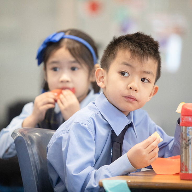 St Bernadette's Catholic Primary Castle Hill students eating lunch in class